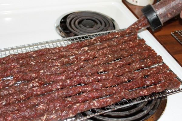 applying snack sticks to grill